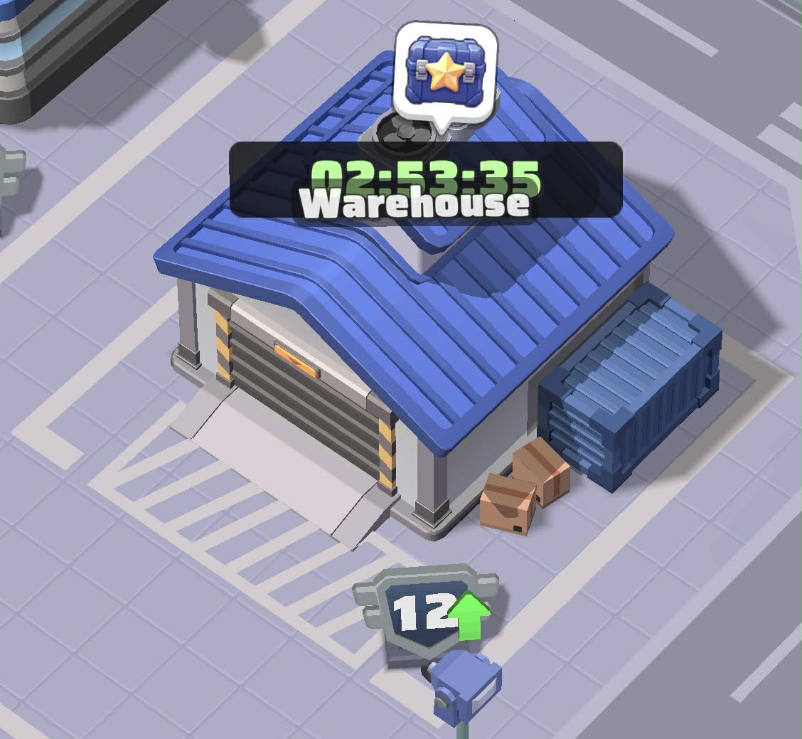 The Warehouse building with a blue roof, grey walls, a roller door and stacked crates